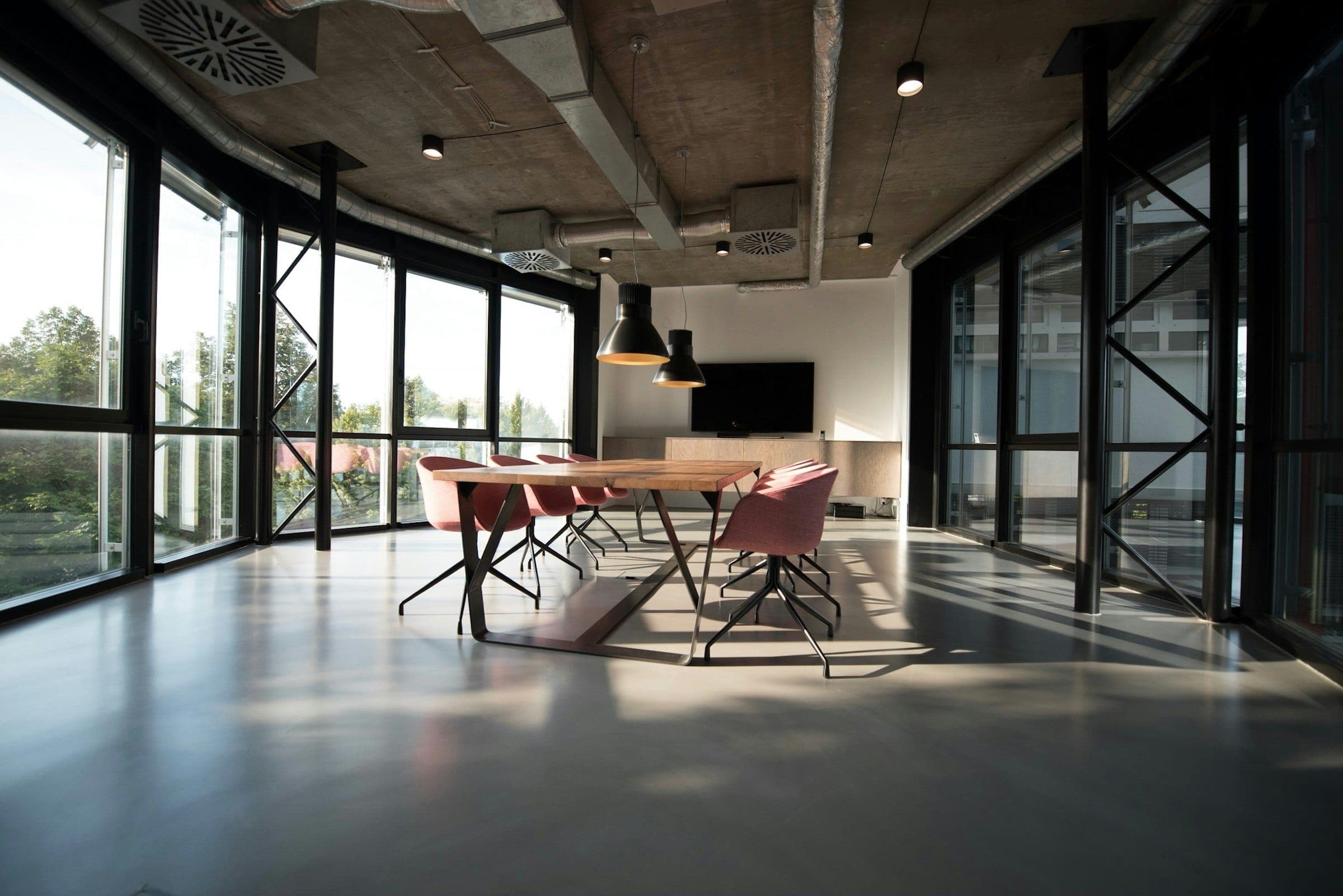 A meeting table still set, with chairs left in place