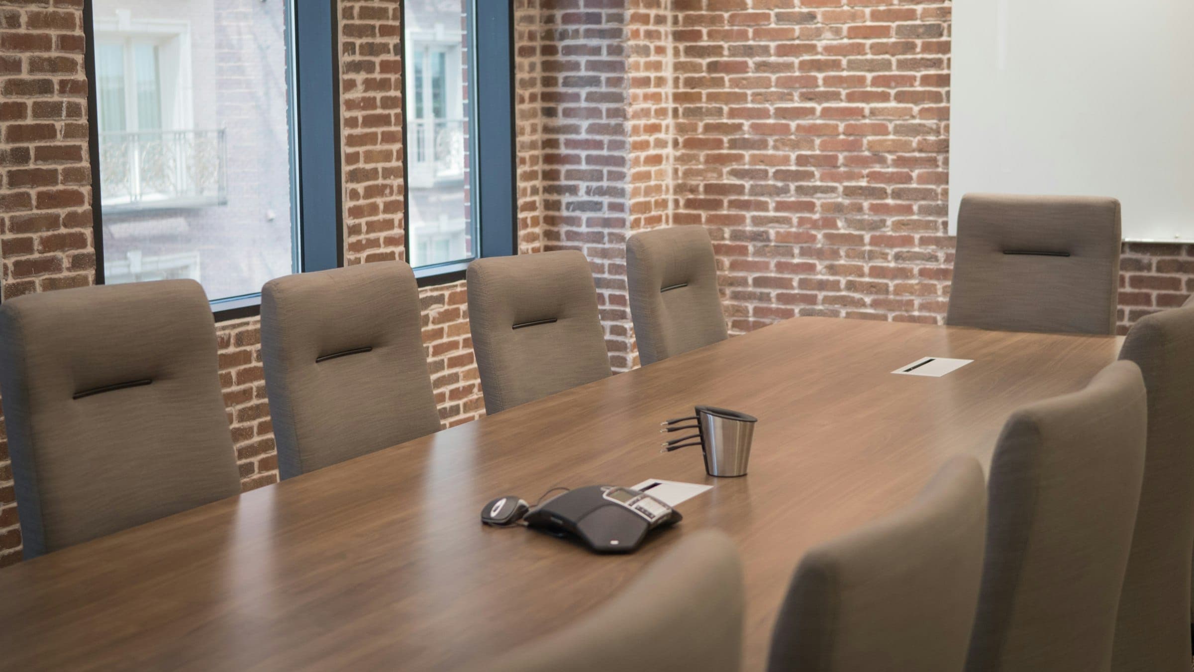 An empty boardroom table set for a negotiation